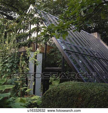 Glass greenhouse in country garden View Large Photo Image Stock Image -  Glass greenhouse in country garden. Fotosearch
