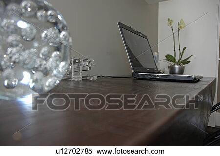 Glass Paperweight On Leather Desk With Laptop Computer In Modern