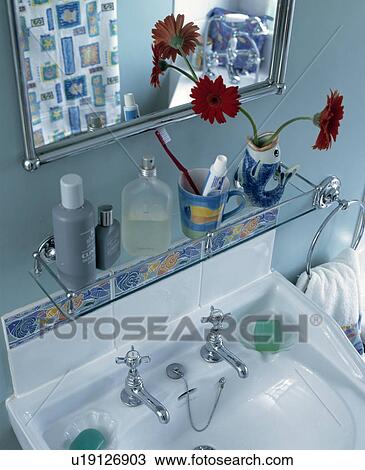 Stock Photo Of Glass Shelf And Mirror Above A White Basin In Blue Glass Shelf And Mirror Above A White Basin In Blue Bathroom