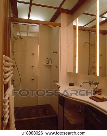 Glass Shower Door And Lighted Ceiling Panels In Modern Neutral