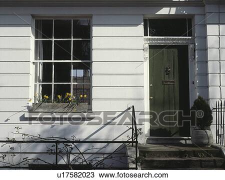 Stock Image - Green front door on traditional Victorian terraced house in North London. Fotosearch