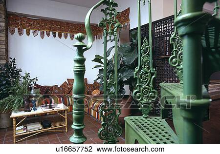 Stock Image - Green metal staircase in sixties living room. Fotosearch