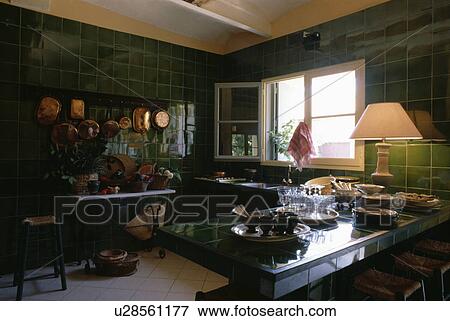 Green wall tiles in kitchen with lighted lamp on worktop View Large Photo Image Stock Photo - Green wall tiles in kitchen with lighted lamp on worktop. Fotosearch