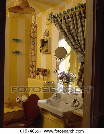 Green+yellow checked curtain above white basin in small bathroom with yellow striped wallpaper View Large Photo Image Stock Photo - Green+yellow checked curtain above white basin in small bathroom with yellow striped wallpaper . Fotosearch