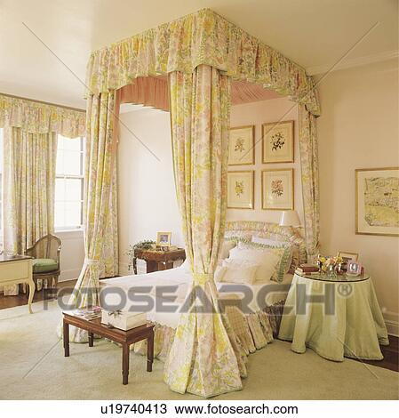 Green+yellow drapes on four-poster bed in traditional bedroom with cream carpet and green cloth on circular table View Large Photo Image Stock Image - Green+yellow drapes on four-poster bed in traditional bedroom with cream carpet and green cloth on circular table. Fotosearch