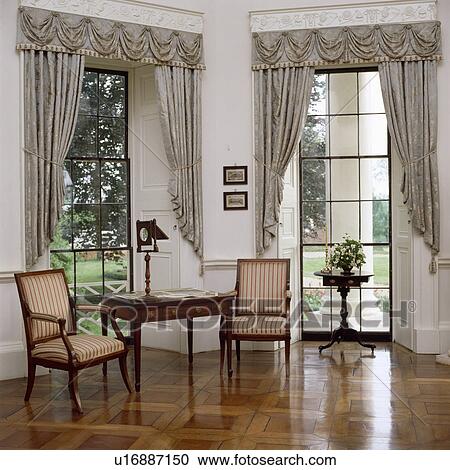 Grey curtains and swagged pelmet in country drawing room with wooden flooring View Large Photo Image Stock Image - Grey curtains and swagged pelmet in country drawing room with wooden flooring. Fotosearch