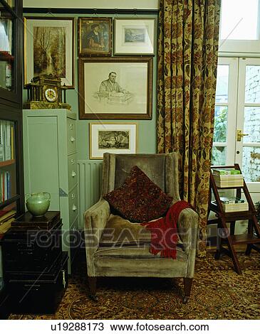 Group of pictures on wall above armchair in traditional living room View Large Photo Image Stock Image - Group of pictures on wall above armchair in traditional living room. Fotosearch