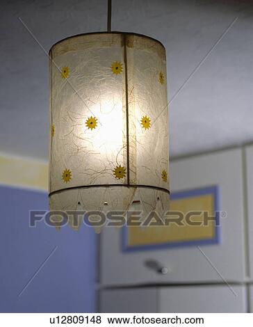Hand made floral paper light shade in a contemporary purple and yellow bedroom View Large Photo Image Stock Photo - Hand made floral paper light shade in a contemporary purple and yellow bedroom. Fotosearch