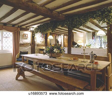 Hops on beam above pine table and bench in beamed cottage dining room View Large Photo Image Stock Image - Hops on beam above pine table and bench in beamed cottage dining room. Fotosearch