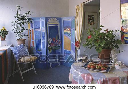 Houseplant on table with patterned cloth in living room with painted folding screen View Large Photo Image Stock Photo - Houseplant on table with patterned cloth in living room with painted folding screen. Fotosearch