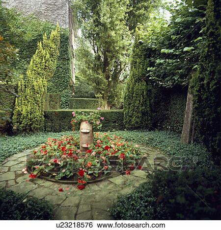Impatiens in paved circular bed in underplanted country garden View Large Photo Image Stock Photograph - Impatiens in paved circular bed in underplanted country garden. Fotosearch