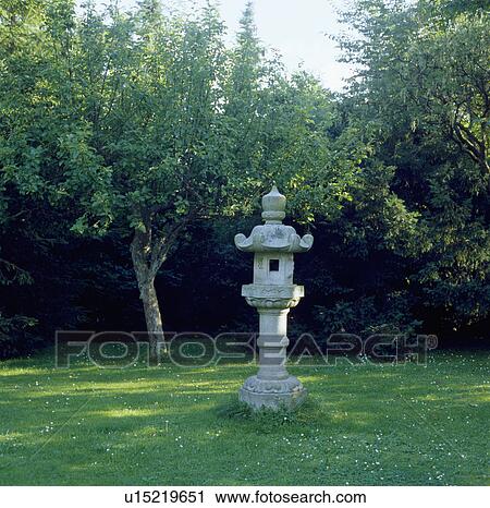 Japanese stone lantern on column in lawn in shady country garden View Large Photo Image Stock Image - Japanese stone lantern on column in lawn in shady country garden. Fotosearch