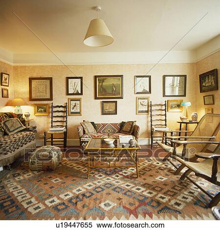Stock Photography - Kelim carpet and antique furniture in country living room. Fotosearch