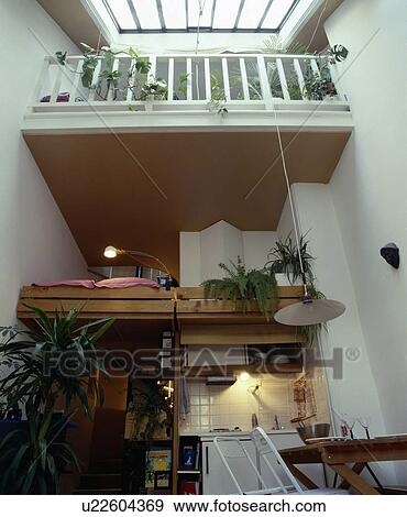 Kitchen below platform bed in bed-sitting room View Large Photo Image Stock Photo - Kitchen below platform bed in bed-sitting room. Fotosearch