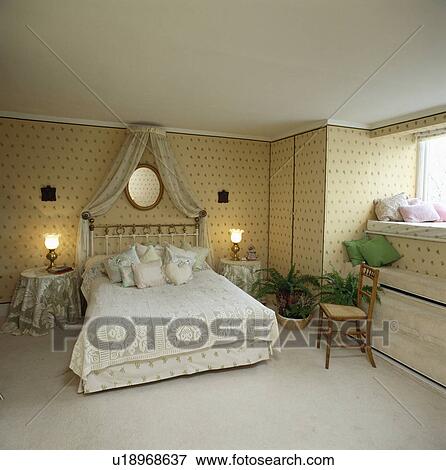 Lace drapes from coronet above bed with lace bedlinen in bedroom with cream carpet and neutral wallpaper View Large Photo Image Stock Photo - Lace drapes from coronet above bed with lace bedlinen in bedroom with cream carpet and neutral wallpaper. Fotosearch