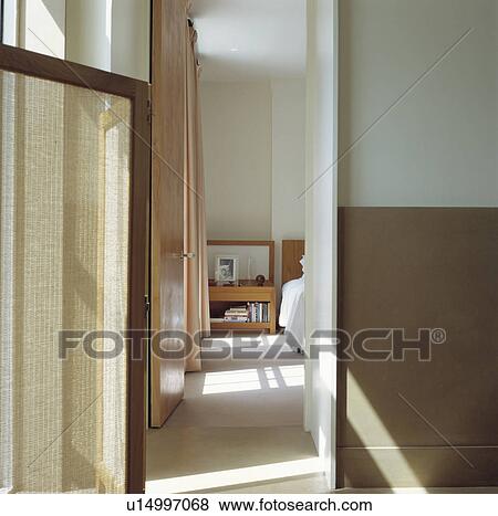 Landing with view through open door to white bedroom View Large Photo Image Stock Photo - Landing with view through open door to white bedroom. Fotosearch