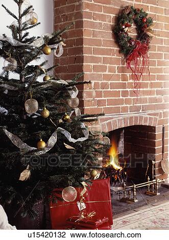 Stock Image - Large Christmas tree and wreath.. Fotosearch