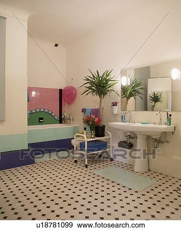 Large modern bathroom with a double basin, patterned tile floor and bath area View Large Photo Image Stock Photo - Large modern bathroom with a double basin, patterned tile floor and bath area . Fotosearch