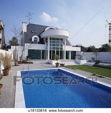 Stock Photo - Large modern white house with swimming pool. Fotosearch