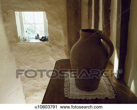 Large pottery jug on shelf on landing with rough white stone wall and small window View Large Photo Image Stock Image - Large pottery jug on shelf on landing with rough white stone wall and small window. Fotosearch