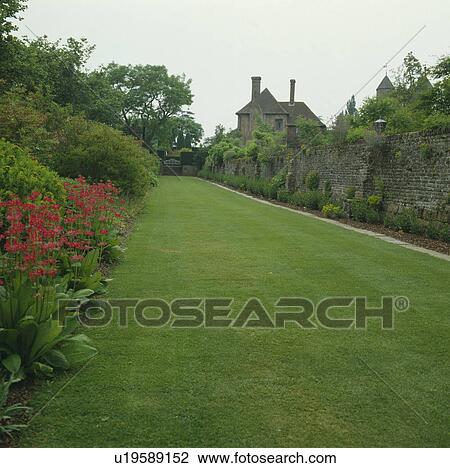 Stock Image - Lawn in large summer country garden. Fotosearch