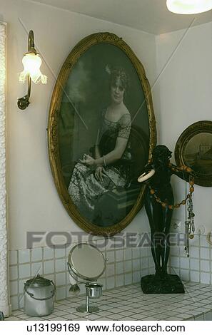 Lighted Edwardian wall light and oval picture View Large Photo Image Stock Photo - Lighted Edwardian wall light and oval picture. Fotosearch