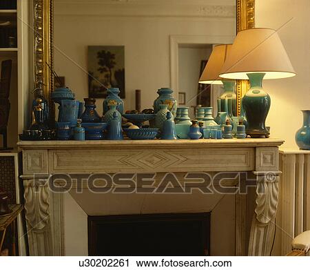 Lighted lamp and collectioon of blue and green vases on mantelpiece View Large Photo Image Stock Image - Lighted lamp and collectioon of blue and green vases on mantelpiece. Fotosearch