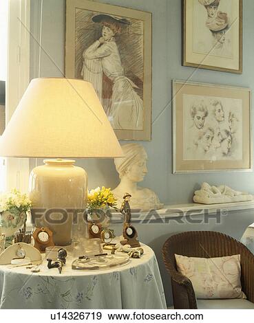 Stock Photo - Lighted lamp on small table. Fotosearch