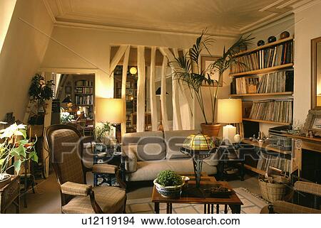 Picture - Lighted lamps in traditional cottage living room. Fotosearch