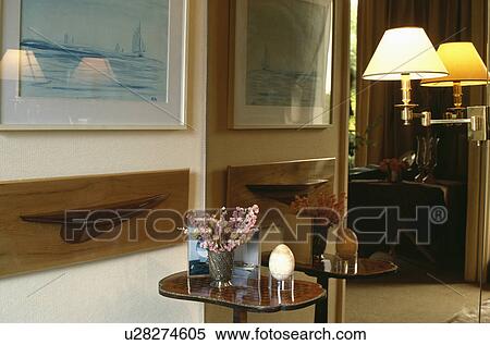 Lighted wall-lamp on mirrored wall View Large Photo Image Stock Photography - Lighted wall-lamp on mirrored wall. Fotosearch