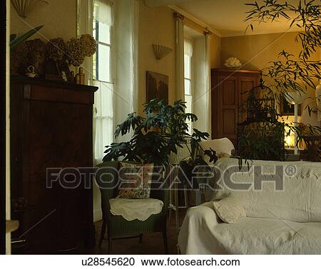 Loosecover on sofa in traditional living room View Large Photo Image Stock Image - Loosecover on sofa in traditional living room. Fotosearch