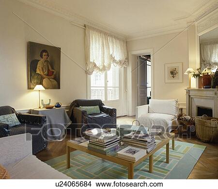 Loosecovers on chairs in apartment living room with festoon blind View Large Photo Image Picture - Loosecovers on chairs in apartment living room with festoon blind. Fotosearch