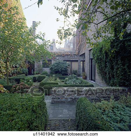 Low clipped hedges in formal town garden View Large Photo Image Stock Image - Low clipped hedges in formal town garden. Fotosearch