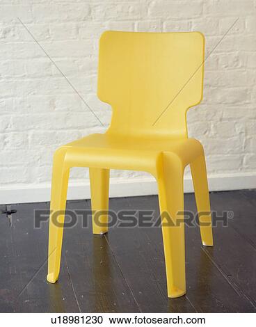 Matthew Hiltons yellow stacking chair View Large Photo Image Stock Image - Matthew Hiltons yellow stacking chair. Fotosearch