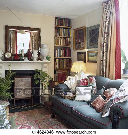 Stock Images Of Mirror Above Marble Fireplace In Living Room With Mirror Above Marble Fireplace In Living Room With Blue Sofa And Alcove Shelving