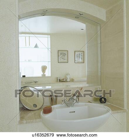 Mirror in recess above built in white basin in modern bathroom View Large Photo Image Stock Photo - Mirror in recess above built in white basin in modern bathroom. Fotosearch