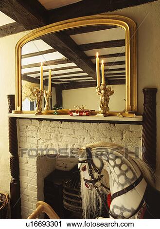Mirror over mantlepiece with candles and rocking horse. View Large Photo Image Stock Image - Mirror over mantlepiece with candles and rocking horse.. Fotosearch