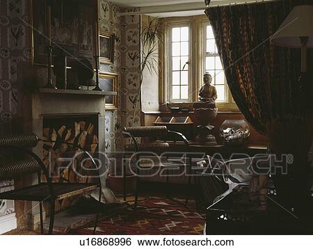 Modern chairs in traditional country dining room with logs in fireplace and dark curtain at the window View Large Photo Image Stock Photograph - Modern chairs in traditional country dining room with logs in fireplace and dark curtain at the window. Fotosearch
