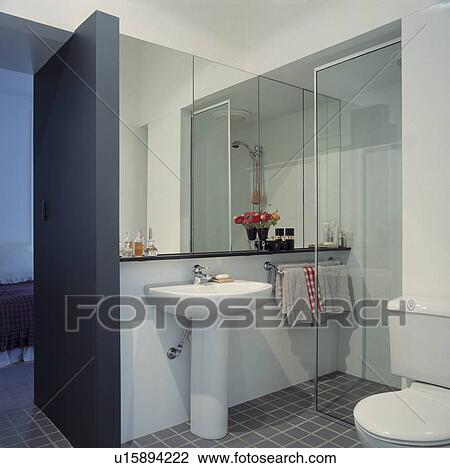 Stock Image - Modern grey and white mirrored shower room. Fotosearch