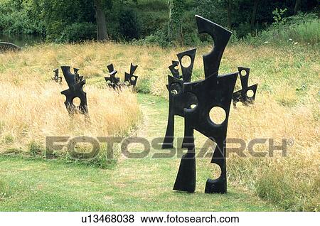 Modern sculpture in long grass in country garden View Large Photo Image Stock Photo - Modern sculpture in long grass in country garden. Fotosearch