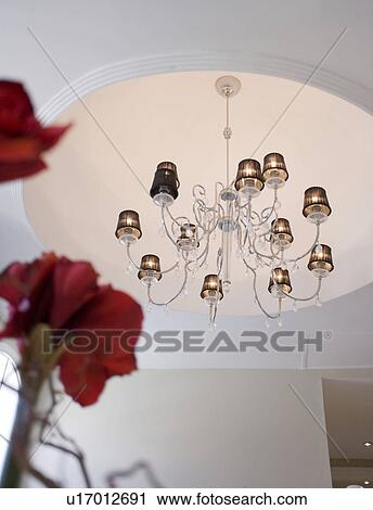 Stock Image - Modern stainless steel chandelier with lampshades. Fotosearch