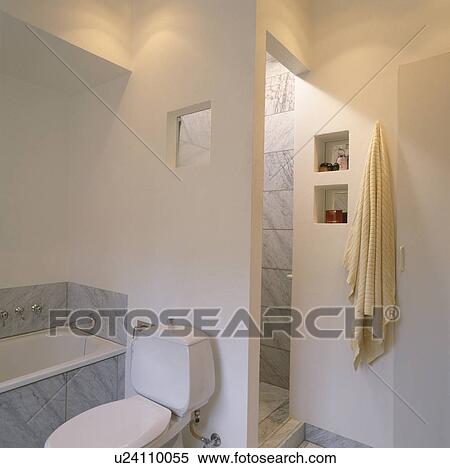 Stock Photography - Modern white bathroom with step in shower. Fotosearch