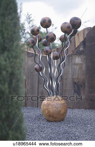 Modern wood and metal sculpture in town garden View Large Photo Image Picture - Modern wood and metal sculpture in town garden. Fotosearch