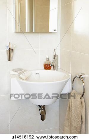 Stock Image - Natural coloured modern bathroom with curved bath. Fotosearch