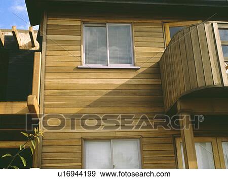 Stock Photo - Newbuild modern house with wooden cladding. Fotosearch
