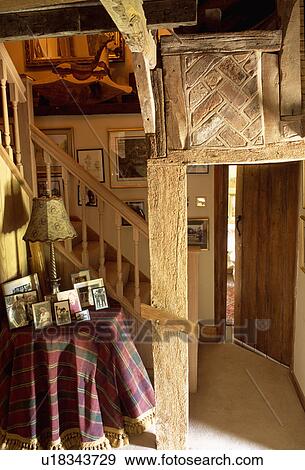 Old brickwork above wooden door frame in beamed country hall with tartan cloth on circular table View Large Photo Image Stock Photo - Old brickwork above wooden door frame in beamed country hall with tartan cloth on circular table. Fotosearch