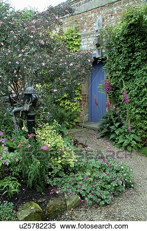 Old garden pump and small water feature in walled country garden View Large Photo Image Stock Photography - Old garden pump and small water feature in walled country garden. Fotosearch