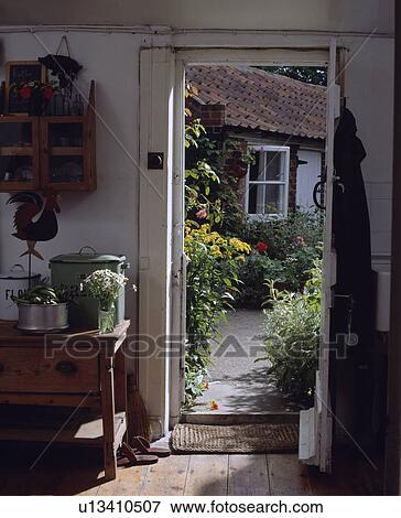 Open door in small white cottage hall with view of the garden View Large Photo Image Stock Photo - Open door in small white cottage hall with view of the garden. Fotosearch