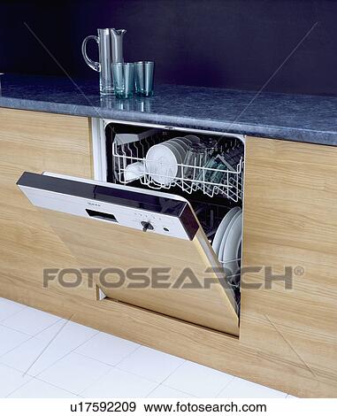 Stock Photo - Open fitted dishwasher below jug on dark grey worktop&#13; &#10; &#13; &#10; &#13; &#10; &#13; &#10; &#13; &#10; &#13; &#10;. Fotosearch