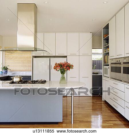Openplan modern kitchen with island unit for hob View Large Photo Image Stock Photography - Openplan modern kitchen with island unit for hob . Fotosearch
